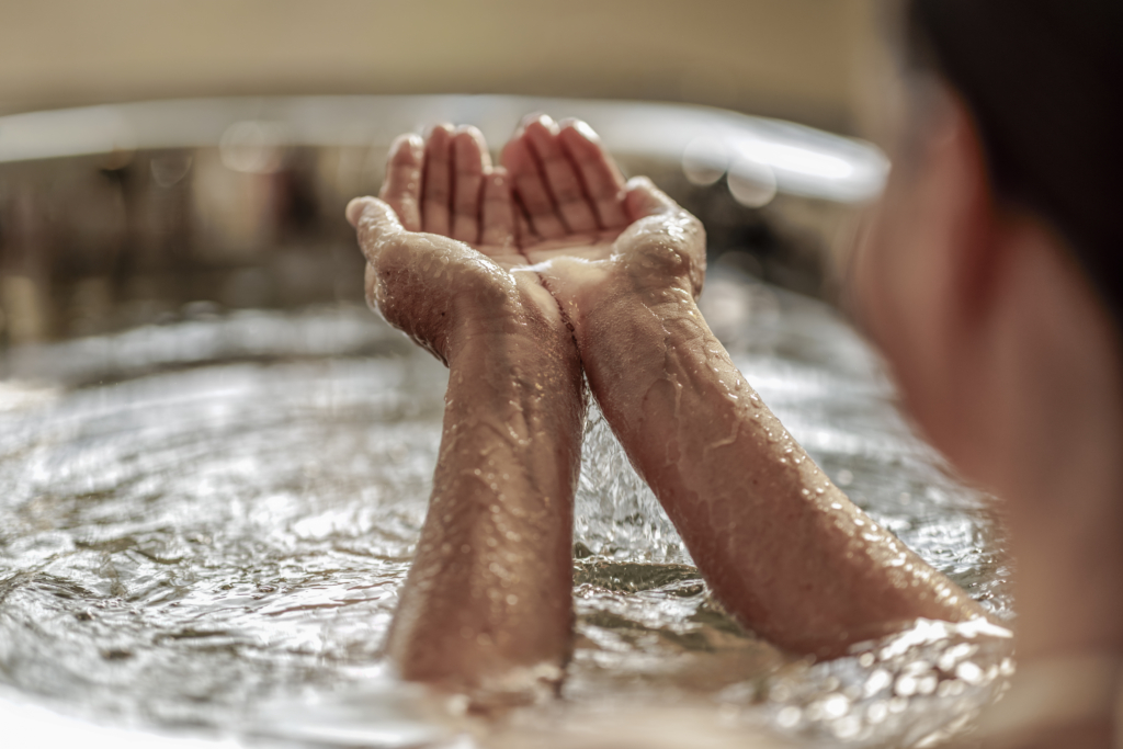 Close-up of hands cupping water