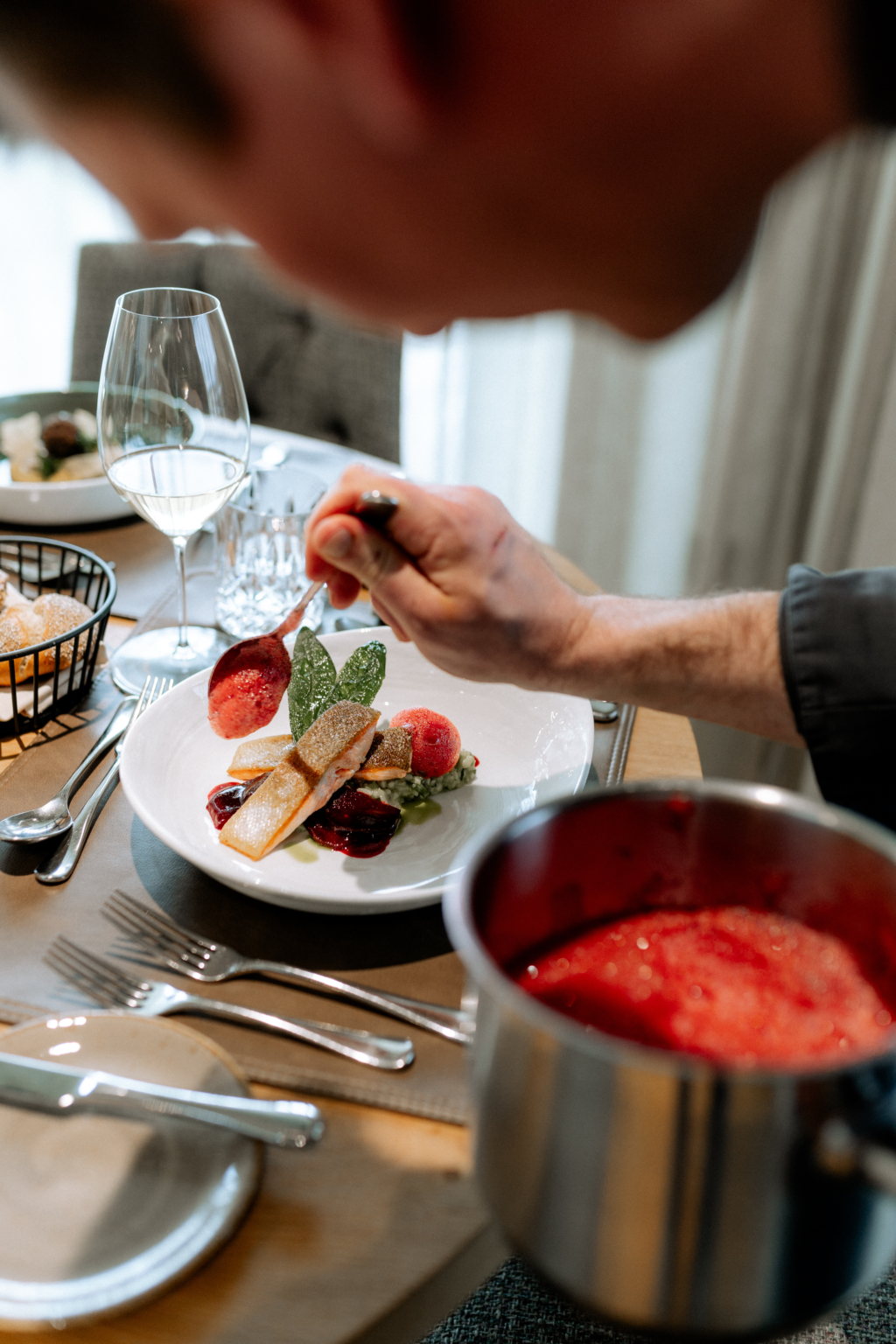 A chef artfully arranging a dessert